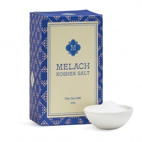 Plate with pink kosher salt, wooden spoon, and dried herbs with overlaid Melach Kosher Salt logo tex